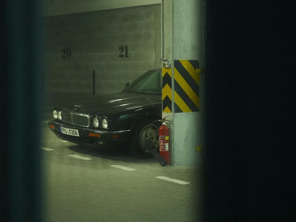 cars parked inside a secure, dim indoor unit, upright