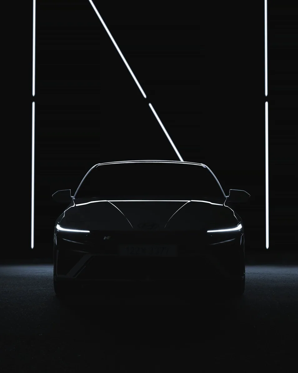 inside the unit — a car on the studio floor under light panels, upright