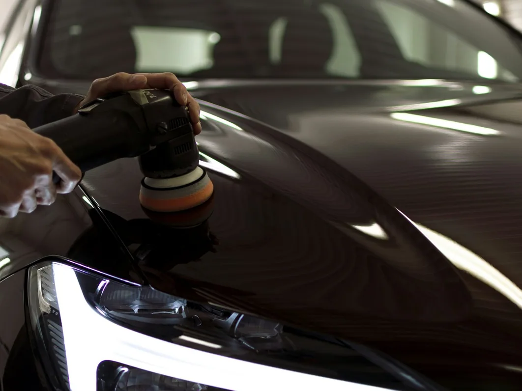 a car being detailed in the studio, hands at work (for Altrincham)