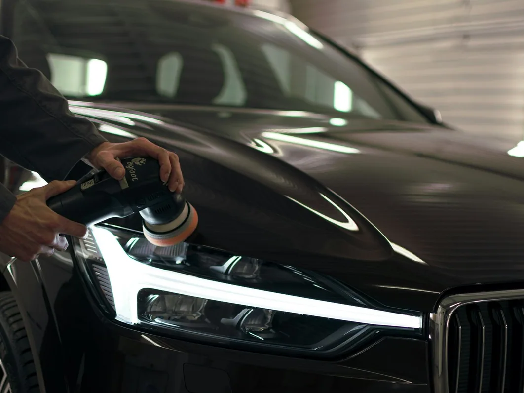 a car being detailed in the studio, hands at work (for Cheadle)