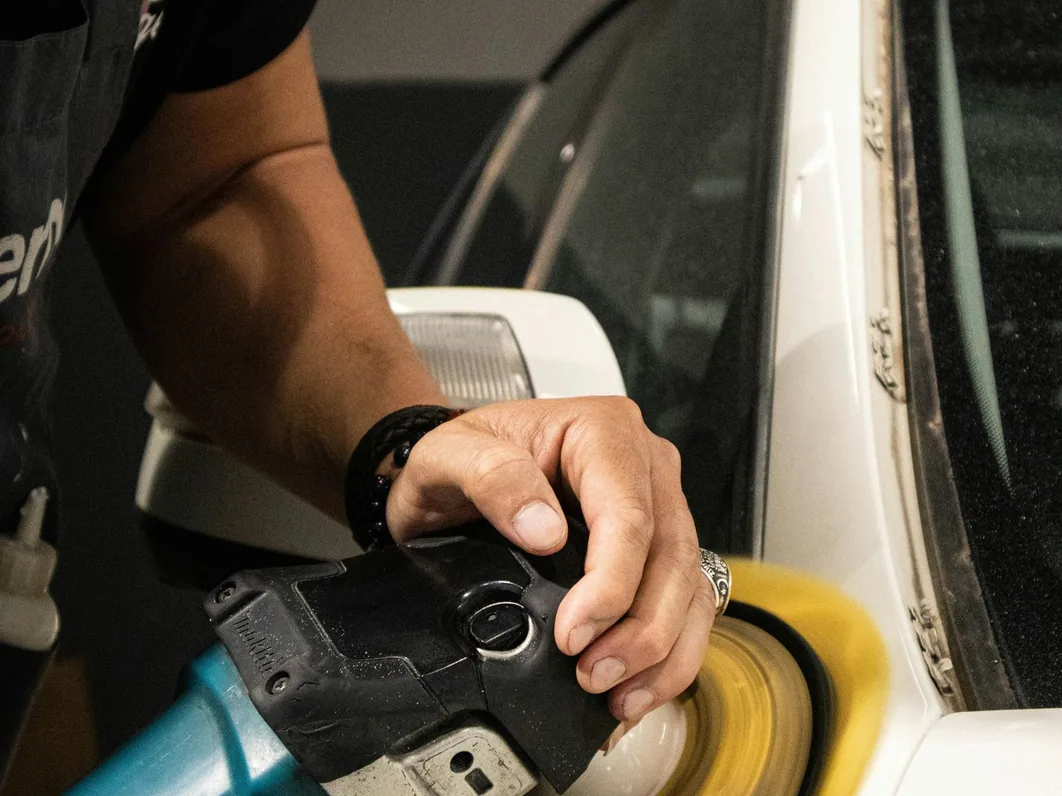 a car being detailed in the studio, hands at work (for Didsbury)