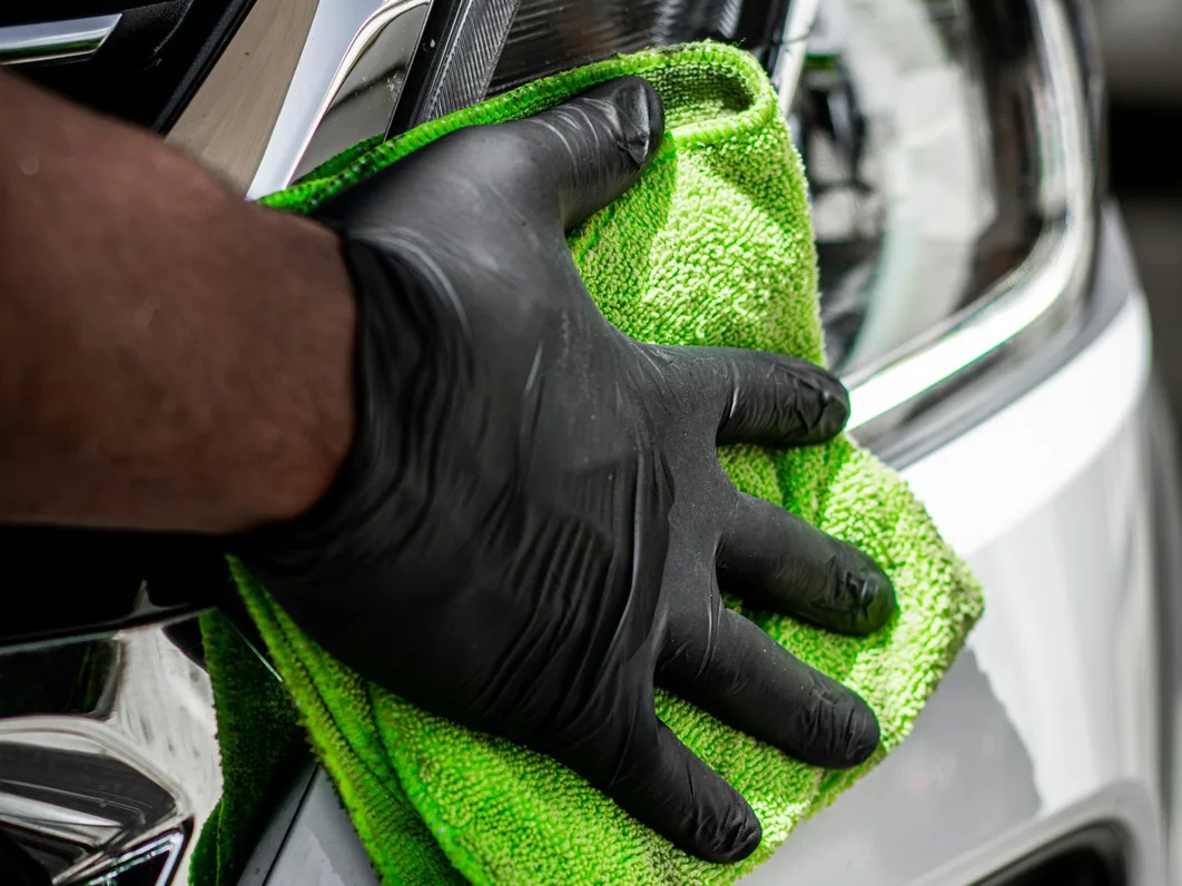 a car being detailed in the studio, hands at work (for Manchester)