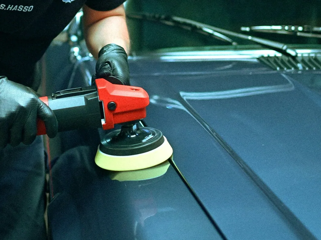 a car being detailed in the studio, hands at work (for Stockport)