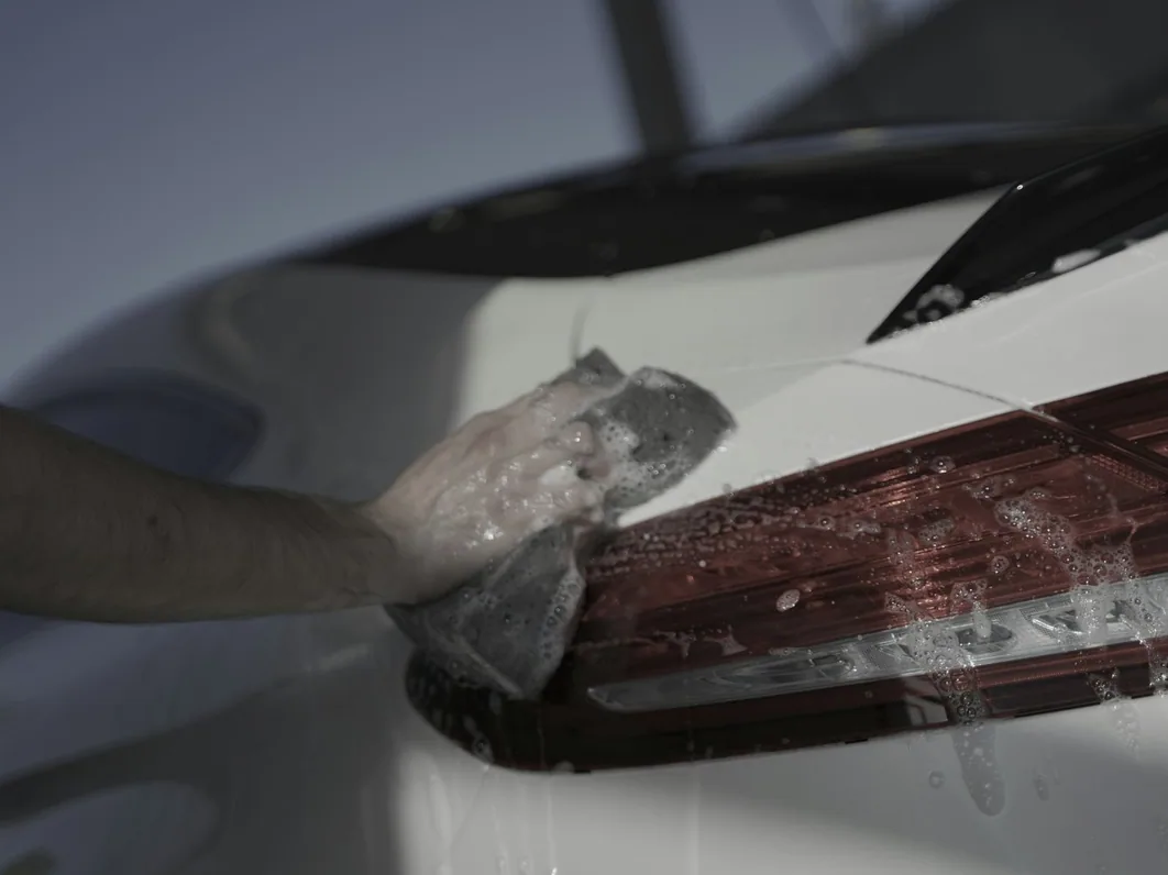 a car being detailed in the studio, hands at work (for Wilmslow)