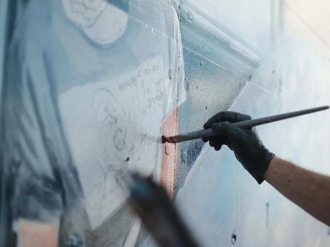 a car being detailed in the studio, hands at work