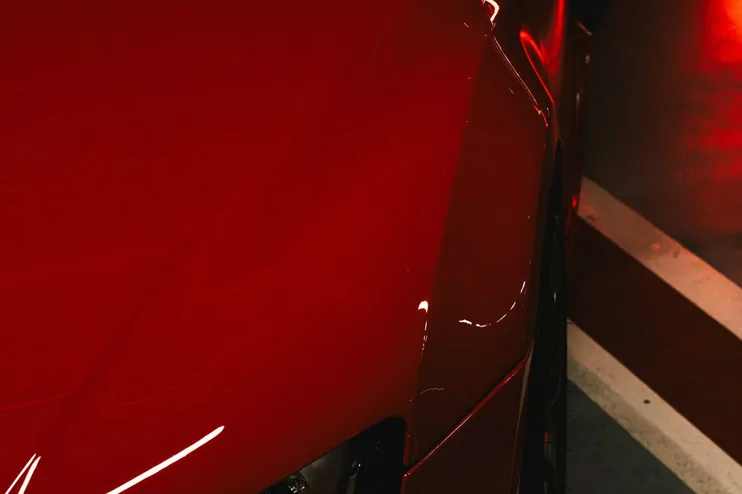 finished paint-corrected car, flank and reflections, studio